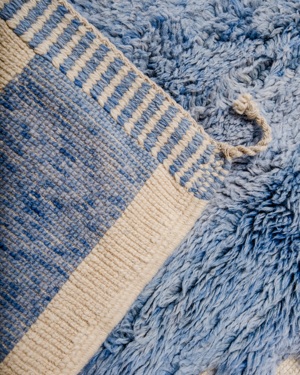 Corner of rug folded over showing the density of the rows of knots that make a Beni M'rirt.